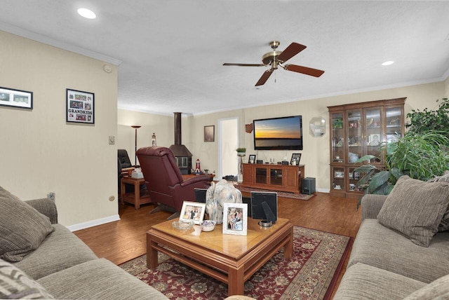 living room featuring crown molding, ceiling fan, and wood-type flooring