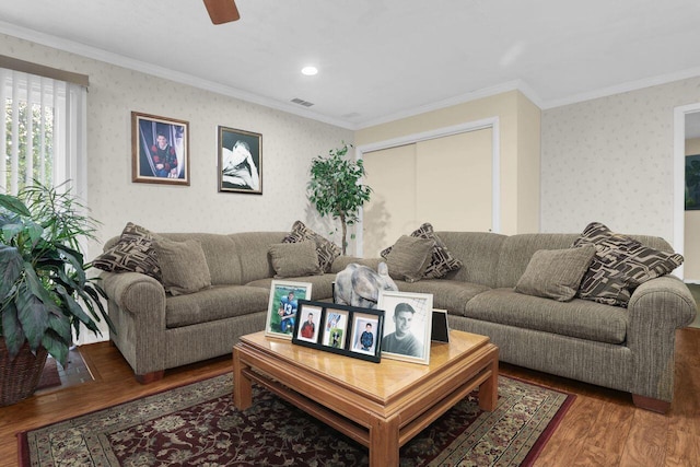 living room featuring ceiling fan, wood-type flooring, and crown molding