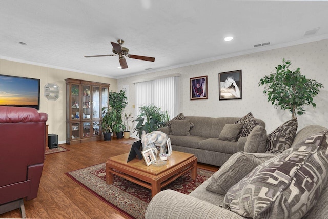 living room featuring ceiling fan, crown molding, and dark wood-type flooring