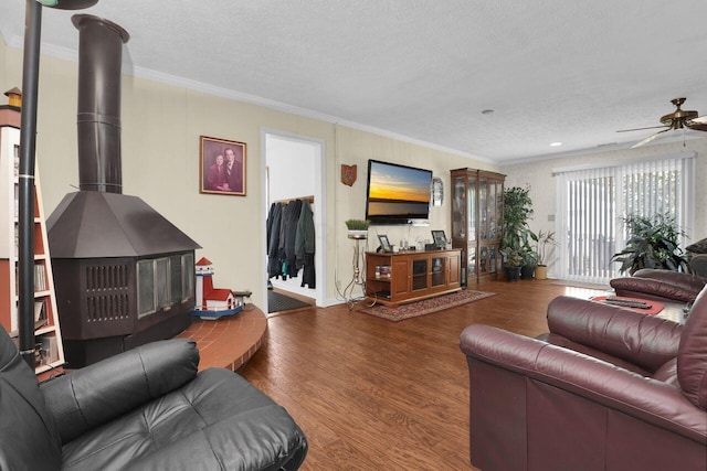 living room featuring hardwood / wood-style floors, ornamental molding, and a textured ceiling