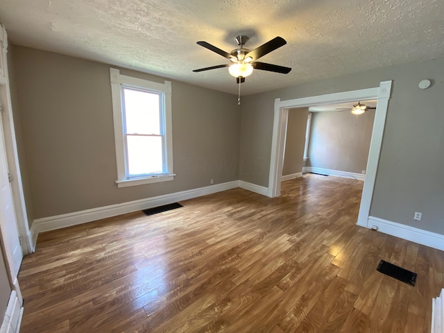 unfurnished room featuring ceiling fan, a textured ceiling, and hardwood / wood-style flooring