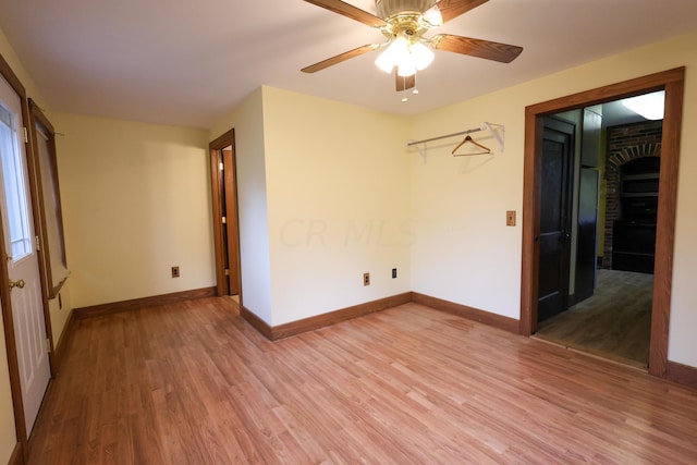 empty room with ceiling fan and hardwood / wood-style flooring