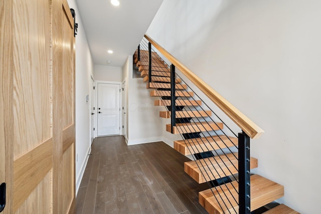 stairway featuring hardwood / wood-style floors and a barn door