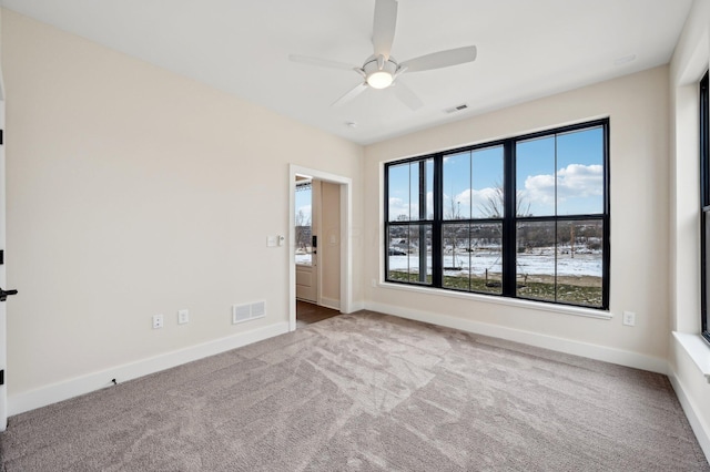 spare room with ceiling fan and carpet floors