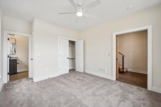 unfurnished bedroom with ceiling fan, a closet, and light carpet