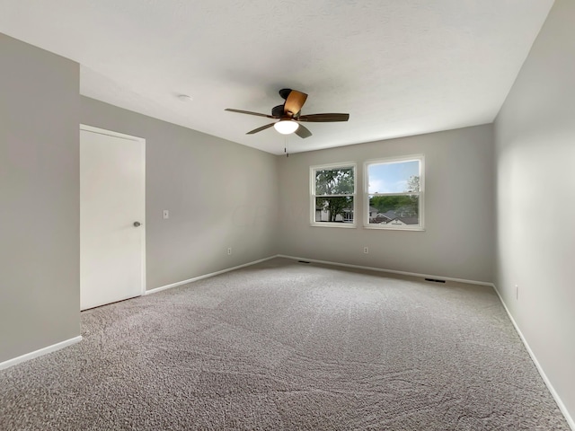 empty room with carpet and ceiling fan