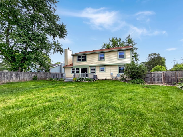 back of property with central AC, a deck, and a lawn