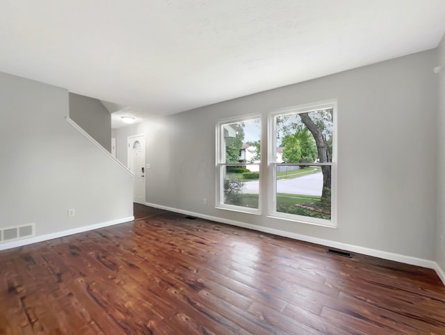 spare room featuring dark hardwood / wood-style flooring