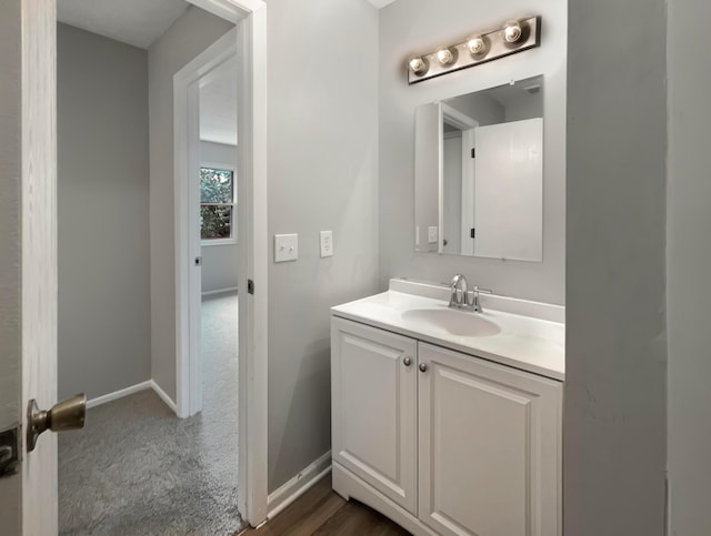 bathroom featuring hardwood / wood-style flooring and vanity