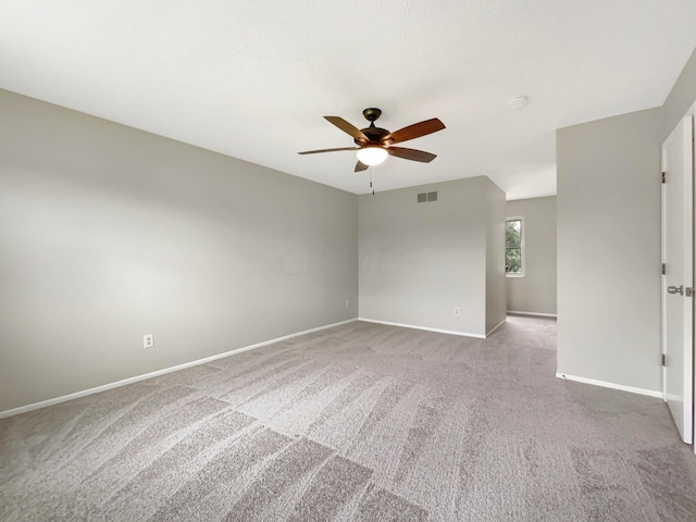 carpeted empty room with ceiling fan