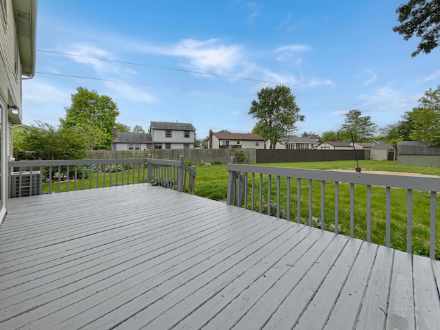 wooden terrace with a lawn