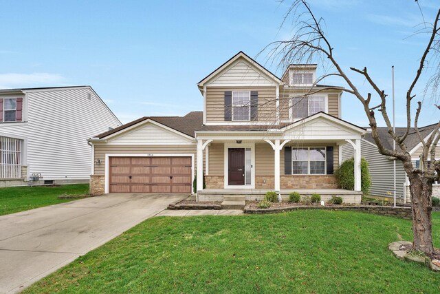 view of front of property featuring a front lawn and a garage