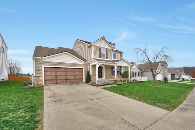 view of front of home featuring a porch, a garage, and a front lawn