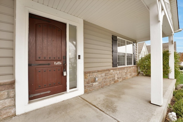 view of exterior entry with a porch