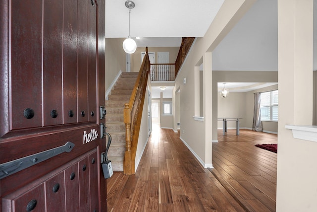 entryway featuring dark hardwood / wood-style flooring and an inviting chandelier