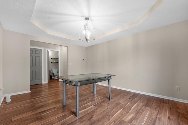 playroom with dark hardwood / wood-style floors and a raised ceiling