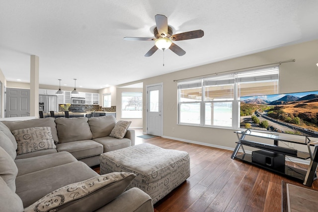 living room with ceiling fan and dark hardwood / wood-style floors