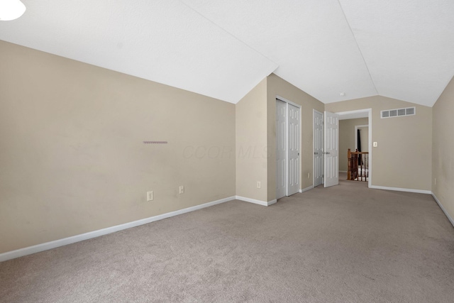 bonus room featuring light colored carpet and lofted ceiling