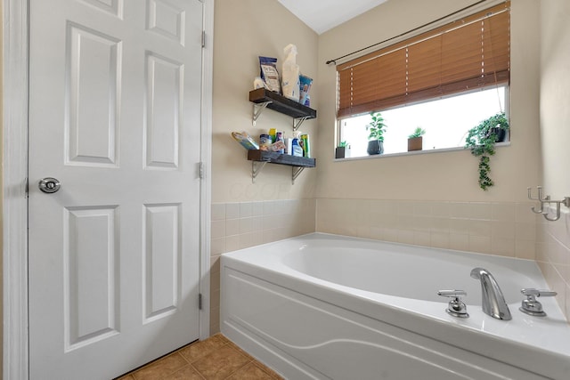 bathroom featuring tile patterned flooring and a bath