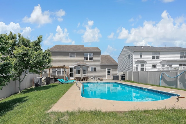 view of pool featuring a yard, a patio, and central AC unit