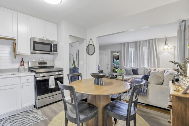 dining room featuring light hardwood / wood-style floors and sink