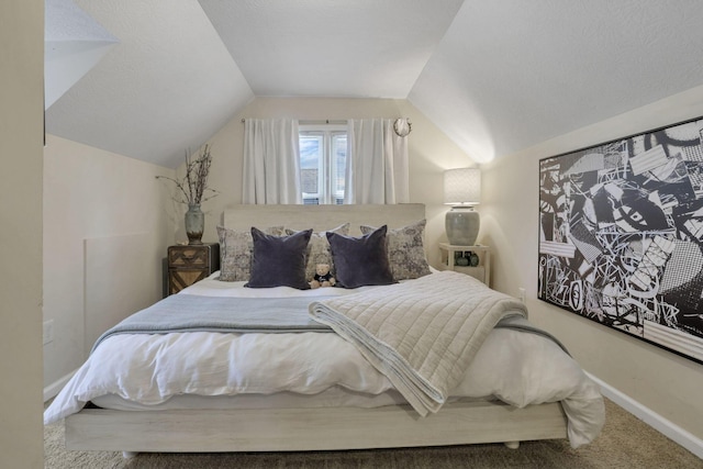 carpeted bedroom with vaulted ceiling