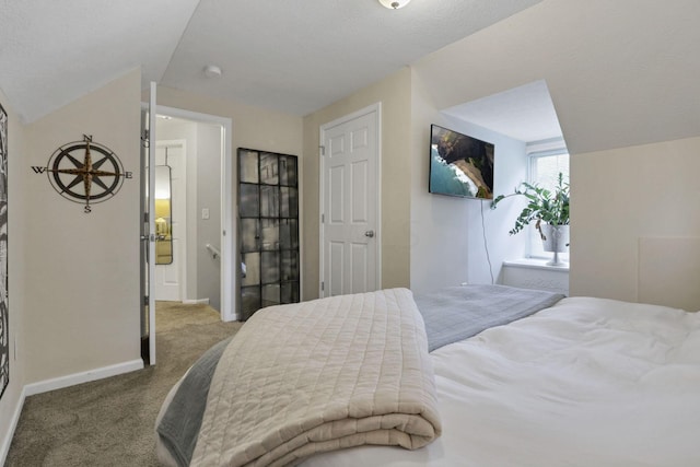 carpeted bedroom featuring a textured ceiling and vaulted ceiling