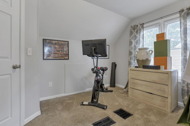 workout room featuring light colored carpet and vaulted ceiling