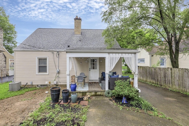 rear view of house featuring a wooden deck and central AC