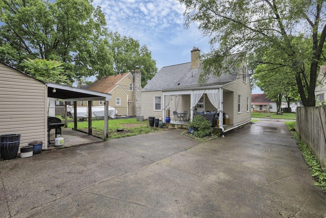 back of house with a carport