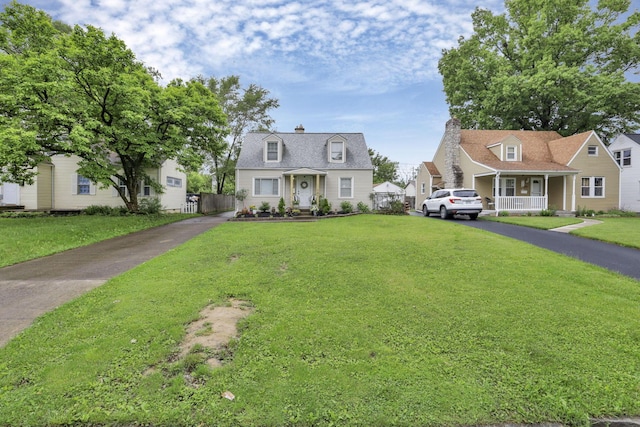 cape cod home with a front lawn