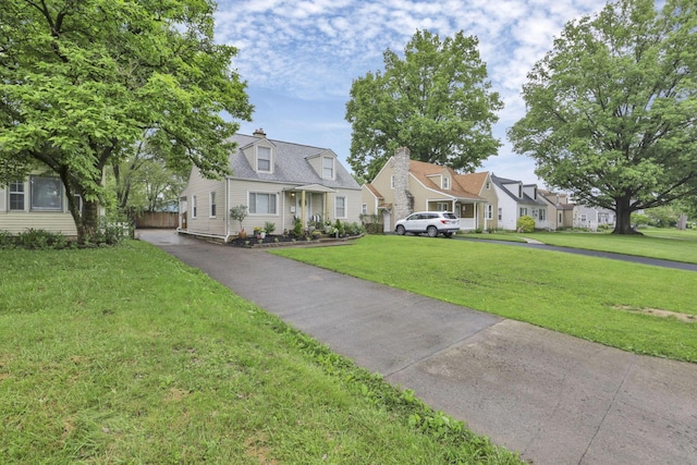 cape cod home featuring a front yard