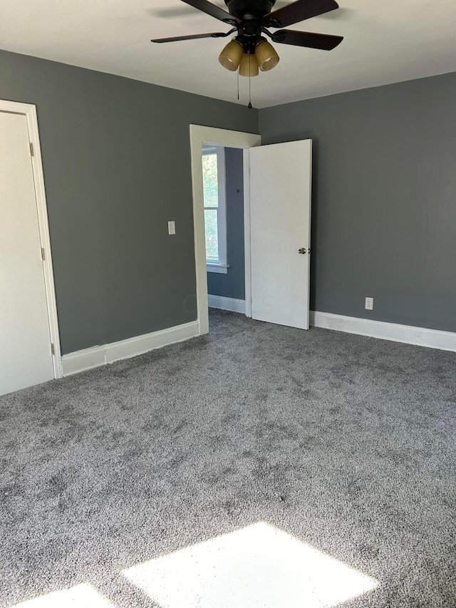 empty room with carpet and ceiling fan