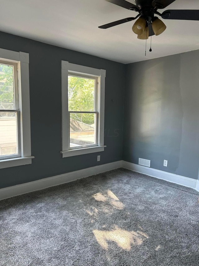 carpeted empty room featuring ceiling fan