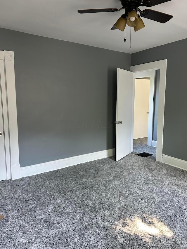 unfurnished room featuring carpet and ceiling fan