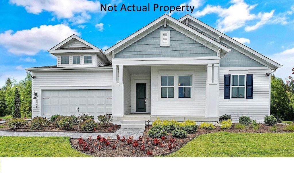 view of front of property featuring a front lawn and a garage