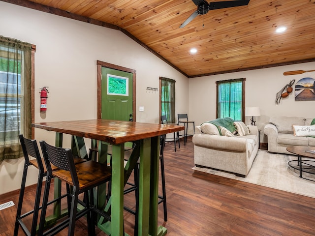 dining area with dark hardwood / wood-style flooring, vaulted ceiling, ceiling fan, and wood ceiling