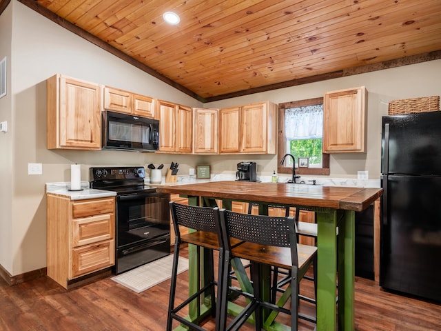 kitchen with light brown cabinetry, wood ceiling, vaulted ceiling, black appliances, and dark hardwood / wood-style floors