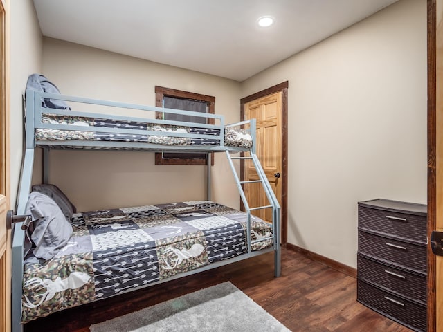 bedroom with dark hardwood / wood-style floors