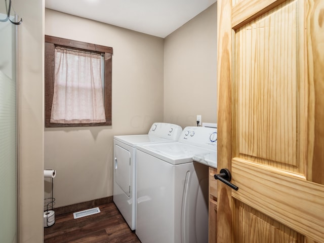 laundry area with dark hardwood / wood-style floors and separate washer and dryer