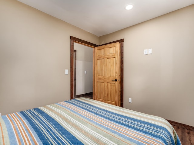 bedroom with dark wood-type flooring