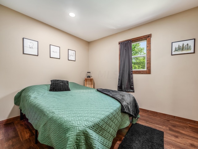 bedroom featuring dark wood-type flooring