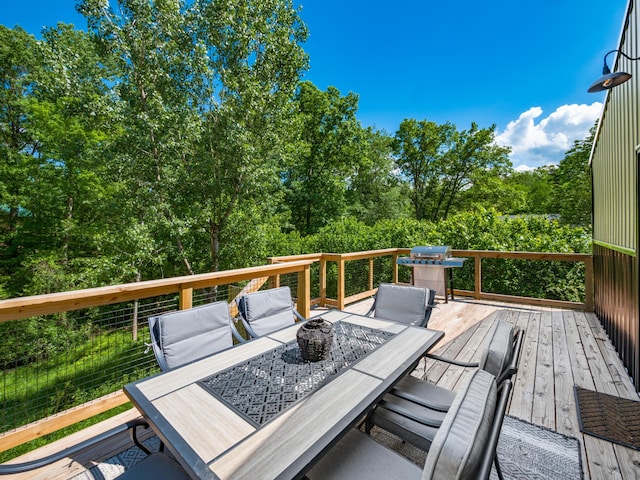 wooden terrace featuring a grill