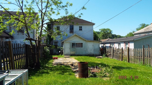 back of property with a lawn