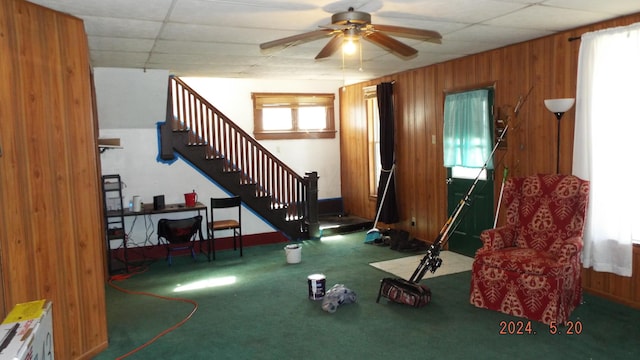 interior space with carpet floors, plenty of natural light, a paneled ceiling, and ceiling fan