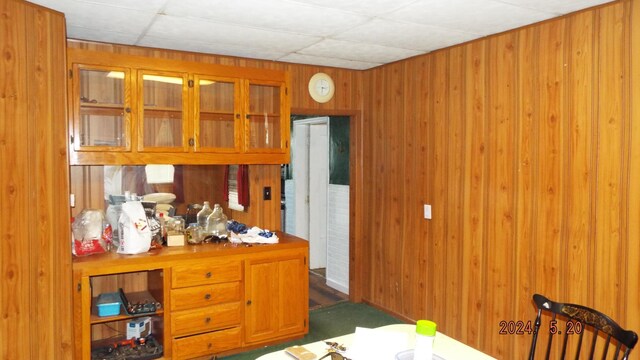 office area featuring wooden walls and a drop ceiling