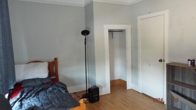 bedroom featuring light hardwood / wood-style flooring and ornamental molding