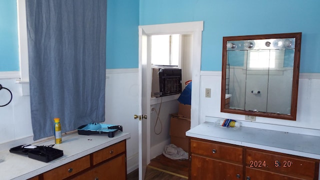 bathroom with vanity, cooling unit, and wood-type flooring