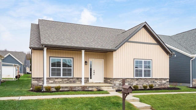 view of front of property with a porch and a front yard