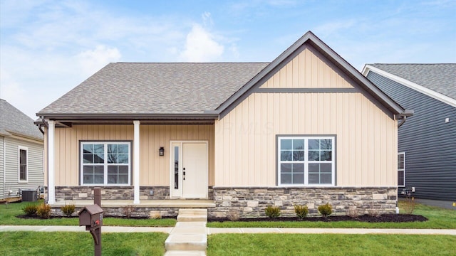 view of front of house featuring a front lawn and central air condition unit